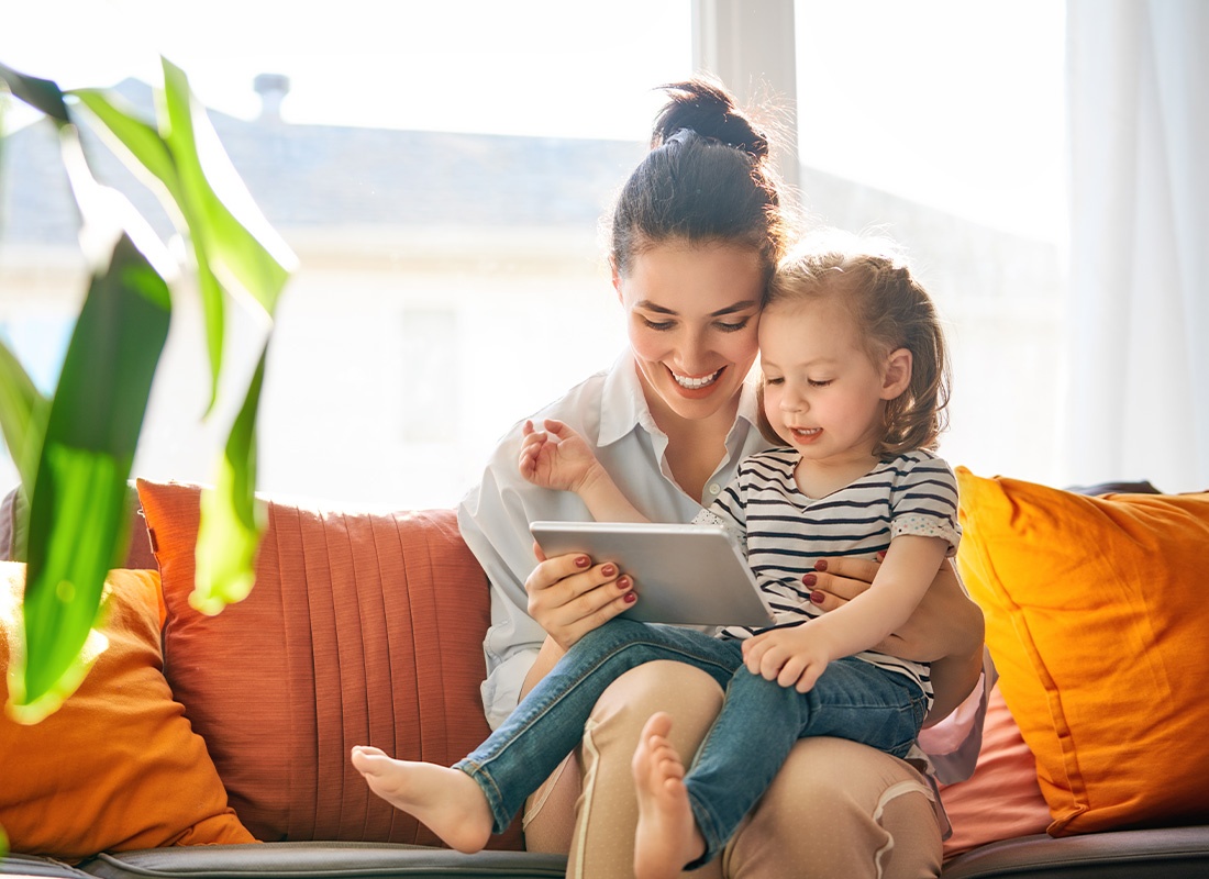 Read Our Reviews - Mom and Child With Tablet on the Sofa of Their Living Room